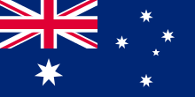 A blue field with the Union Flag in the upper hoist quarter, a large white seven-pointed star in the lower hoist quarter, and constellation of five white stars in the fly – one small five-pointed star and four, larger, seven-pointed stars.