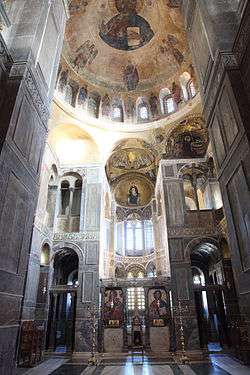Interior of the central naos of the monastery of Hosias Loukas, showing the large dome and fresco of Christ Pantokrator with a ring of windows in the base of the dome and pendentives formed by the eight supporting arches, four of which contain squinches that rest on the four corners of the square walls of the space