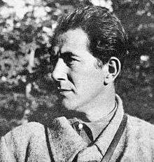 a back and white head and shoulders left profile photograph of a male with dark hair