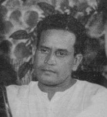 A black and white photograph of a young man